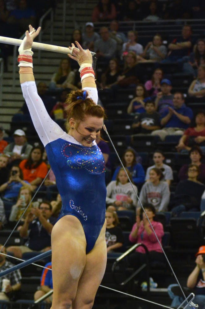 Bridget Sloan smiles after finishing her routine on the uneven parallel bars during the Southeastern Conference Championships on March 21 at the Arena at Gwinnett Center in Duluth, Georgia. Sloan earned a perfect 10.0 on the event.