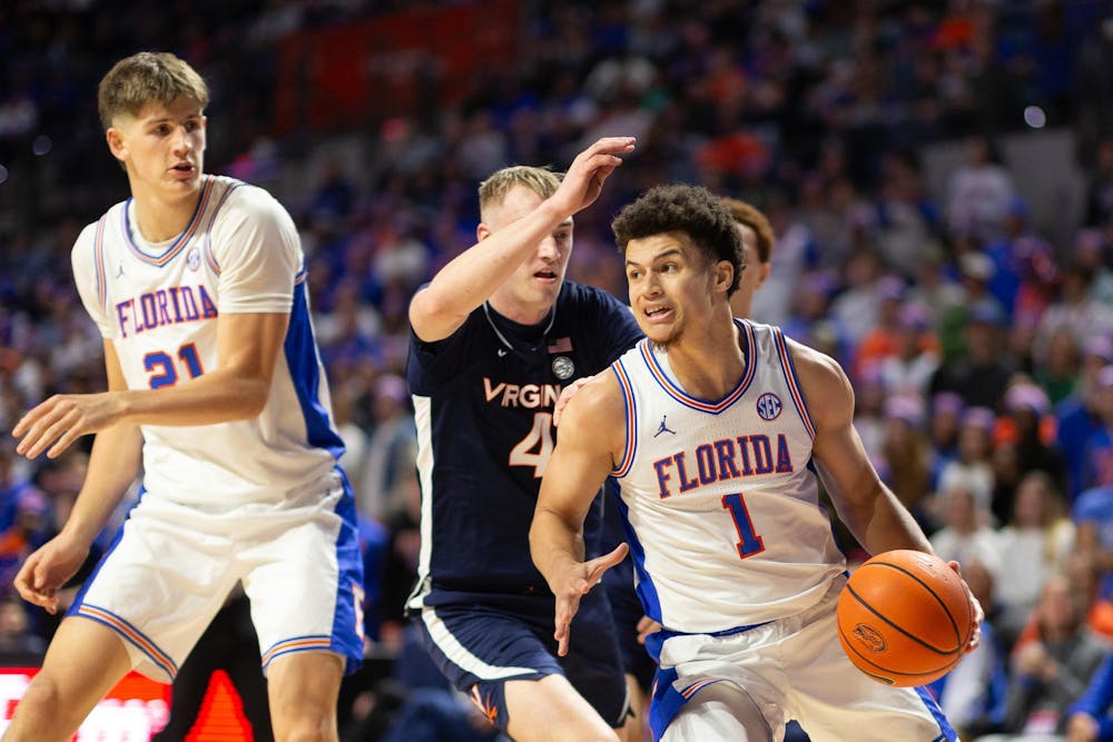 Florida Gators Guard Walter Clayton Jr. (1) dribbles the ball during the second half against the Virginia Cavaliers at Exactech Arena at the Stephen C. O'Connell Center on Wednesday, Dec. 4, 2024.