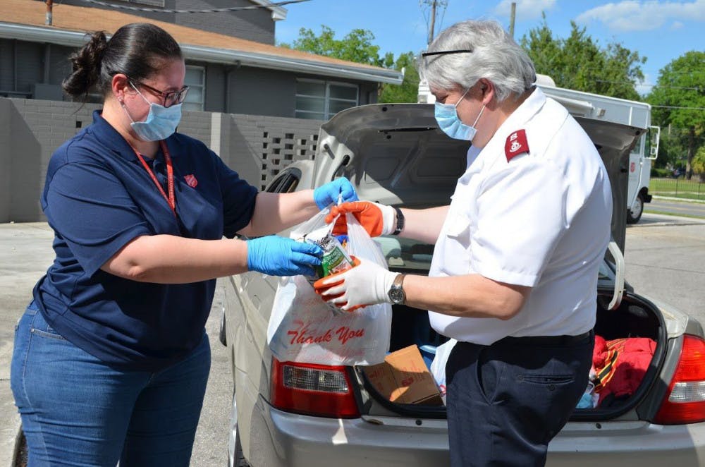 Priscilla Gonzalez helps to distribute supplies during The Salvation Army's food drive event Wednesday.