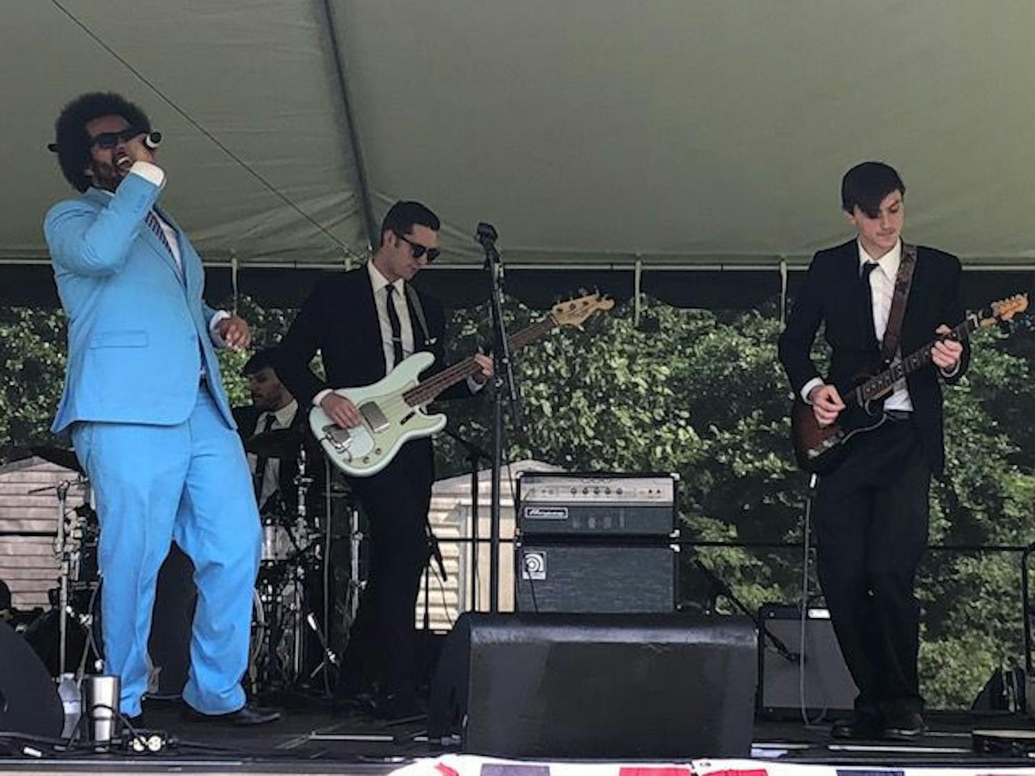 UF student Matt Fowler plays guitar with the Savants of Soul on stage in the field.
&nbsp;