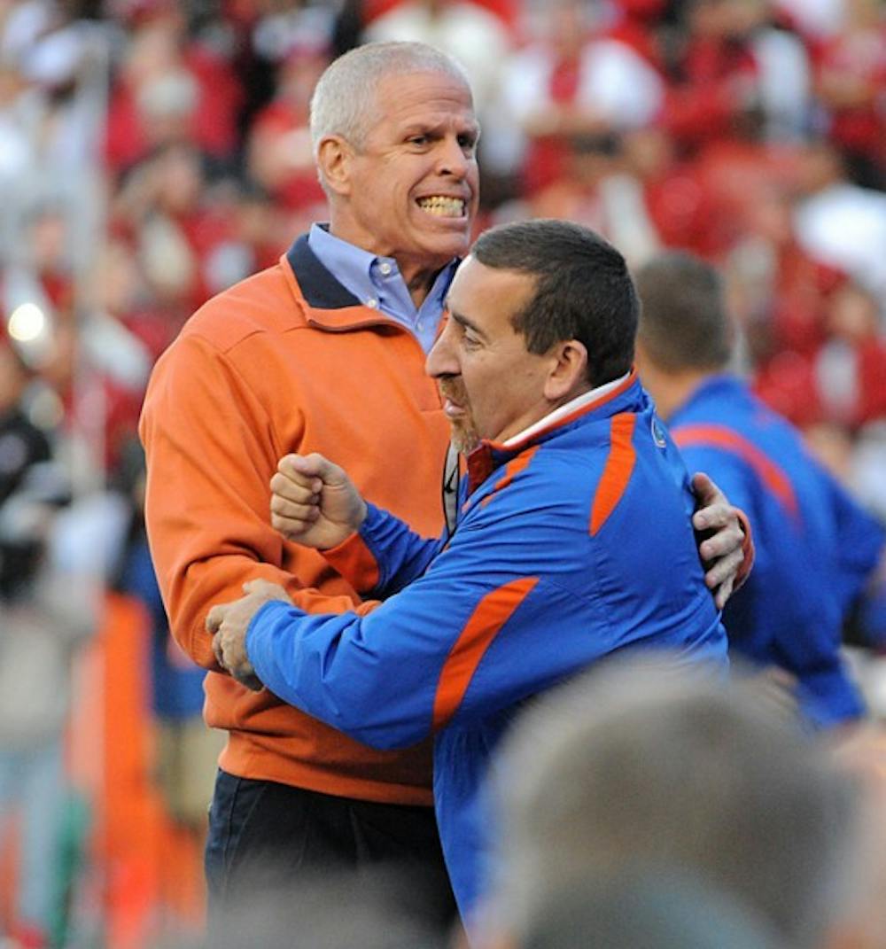 <p>UF athletics director Jeremy Foley hugs a staffer as he celebrates a touchdown on Oct. 17, 2009. Foley announced his support for coach Will Muschamp before Florida's game against Florida State on Nov. 30, 2013.&nbsp;</p>