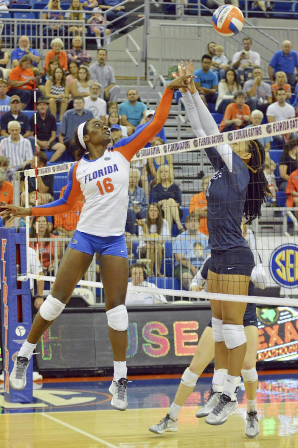 <p>UF middle blocker Simone Antwi tips a ball over the net during Florida's 3-0 win against Ole Miss on Sept. 28, 2014, in the O'Connell Center.</p>