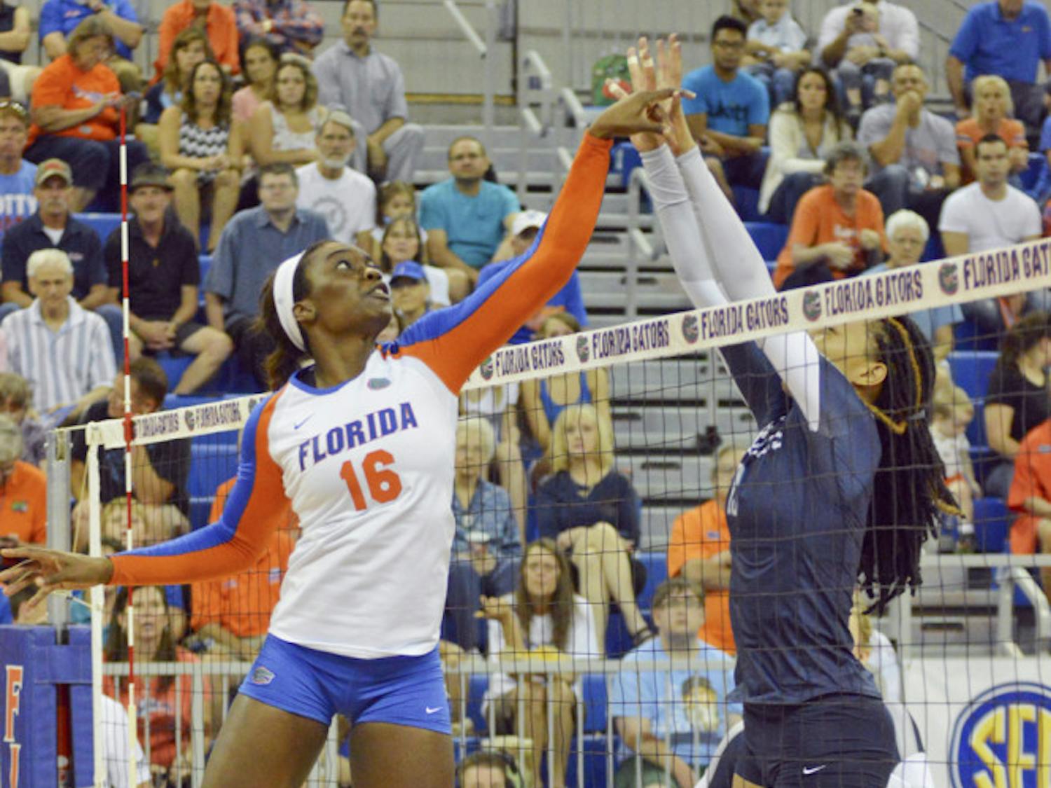 UF middle blocker Simone Antwi tips a ball over the net during Florida's 3-0 win against Ole Miss on Sept. 28, 2014, in the O'Connell Center.