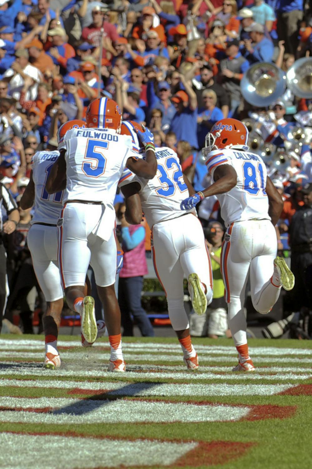 <p>UF players celebrate with running back Jordan Cronkrite after his 41-yard touchdown during Florida's 24-14 win against South Carolina on Nov. 14, 2015, at Williams-Brice Stadium in Columbia, South Carolina.</p>