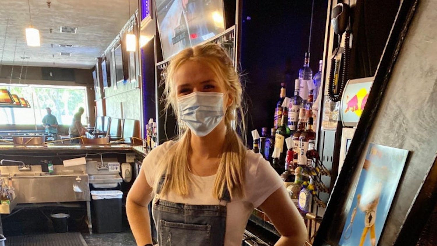 A Silver Q employee wears masks and practices proper hygiene while behind the bar.