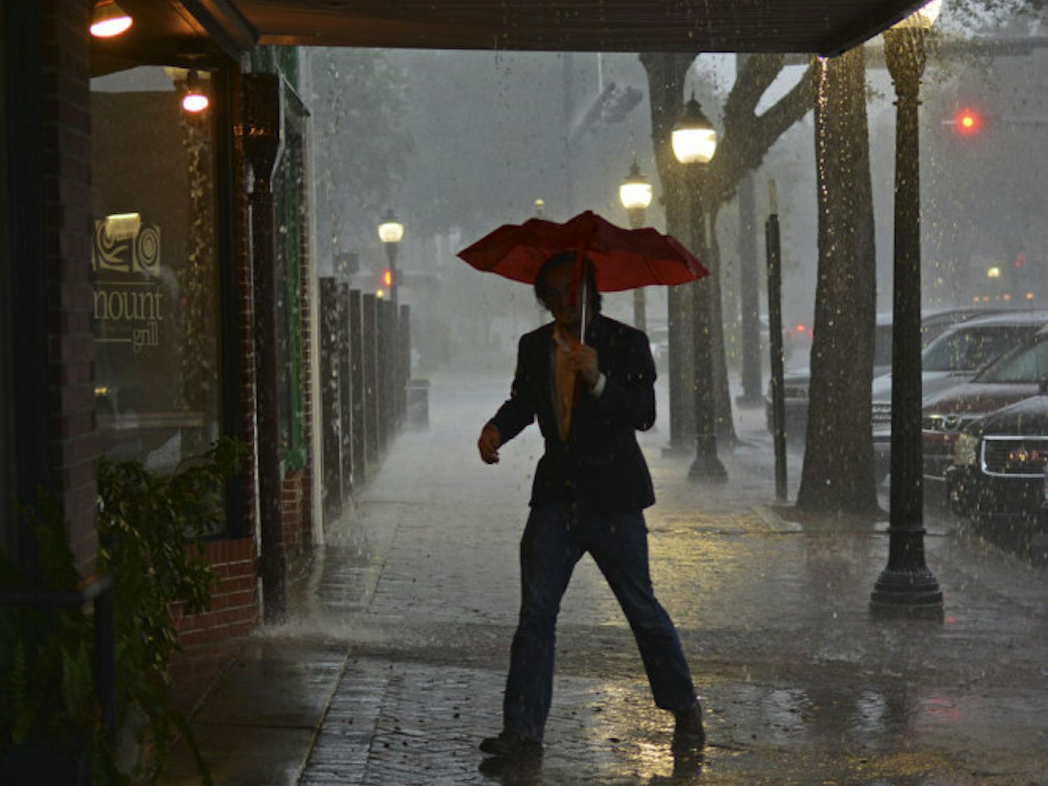 Anthony De Lamarter takes shelter from the rain in downtown Gainesville on Sunday.