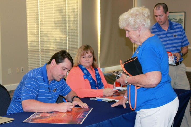Will Muschamp signs autographs Tuesday afternoon after a press conference at Emerson Hall to discuss his plans for the upcoming season, which begins Aug. 30.