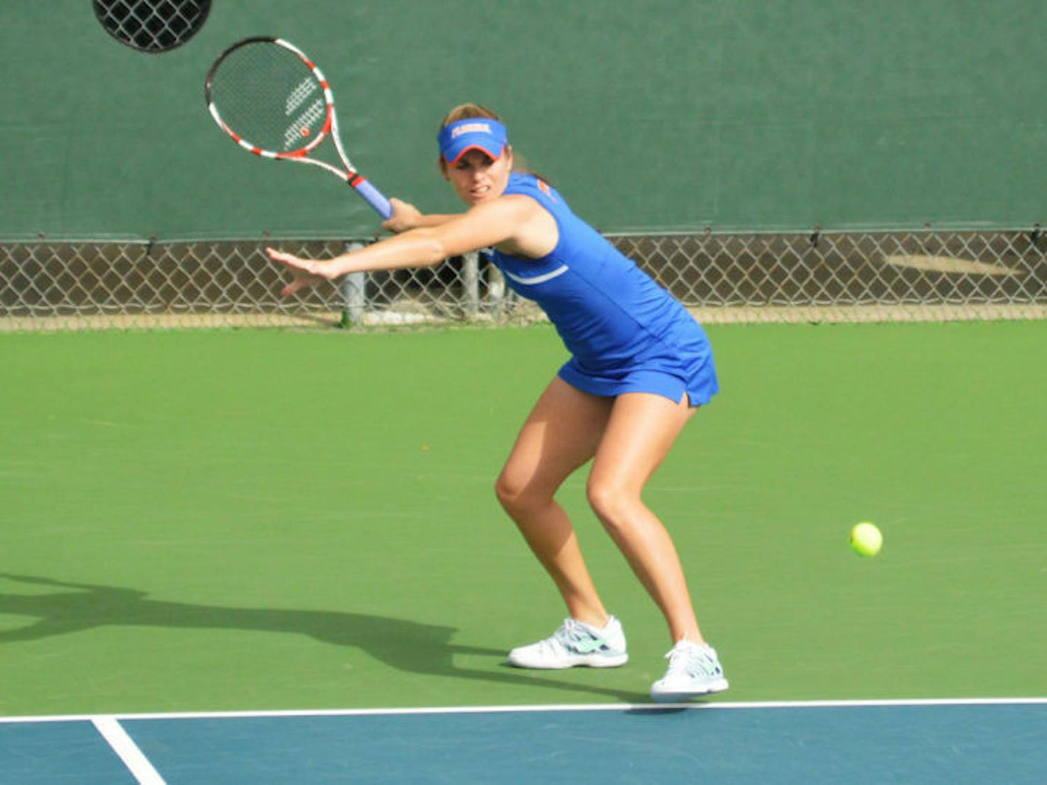 Belinda Woolcock swings at the ball during Florida’s 4-0 win against Louisville on Jan. 25 at the Ring Tennis Complex.