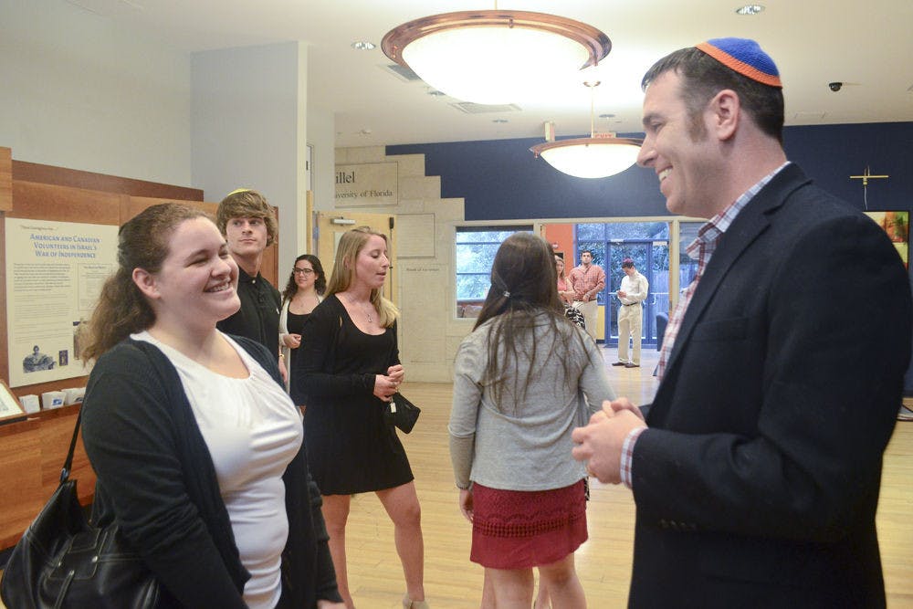 UF Hillel’s new rabbi, Adam Grossman, talks with Laura Salas, a 22-year-old UF mechanical engineering senior, before Rosh Hashanah services.