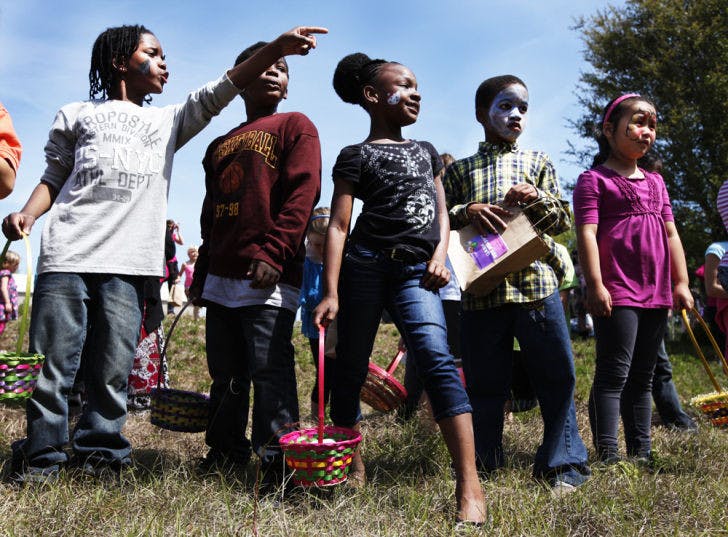 Children point out Easter eggs as they wait to begin the festivities at Abundant Grace Community Church’s second annual Easter egg hunt Saturday.