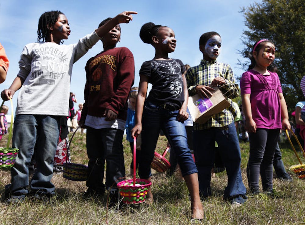 <p>Children point out Easter eggs as they wait to begin the festivities at Abundant Grace Community Church’s second annual Easter egg hunt Saturday.</p>