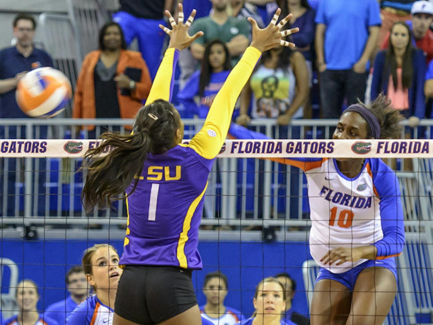 Redshirt senior middle blocker Chloe Mann spikes the ball, after a set-up by fellow senior Taylor Brauneis, for the match-winning kill during No. 7 Florida's sweep of LSU on Friday night in the O'Connell Center.