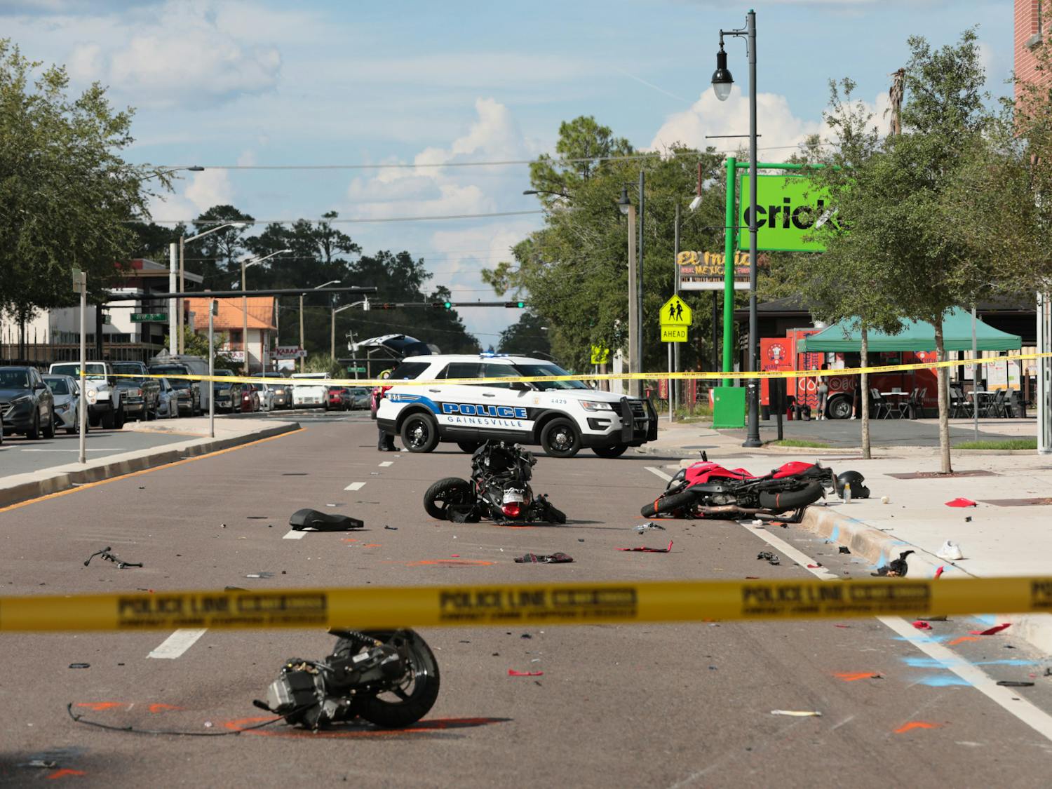 Remnants of a motorcycle accident are seen on the corner of 3rd Avenue and West University Avenue in front of Krispy Kreme on Friday, Oct. 1, 2021.