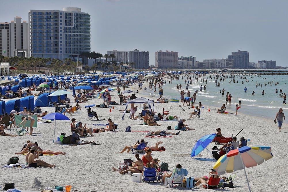 <p>Visitors enjoy Clearwater Beach, Wednesday, March 18, 2020, in Clearwater Beach, Fla. Beachgoers are trying to keep a safe distance from each other by keeping a space of 6 to 10 feet (2 to 3 meters) between family groups to help protect from the spread of the coronavirus. (AP Photo/Chris O'Meara)</p>