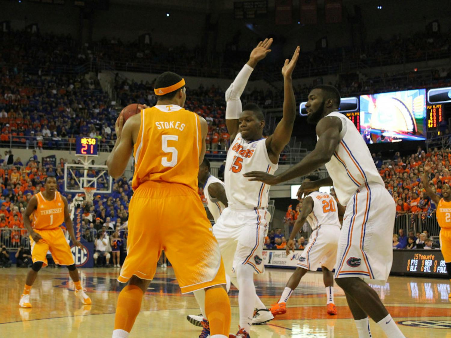 Will Yeguete (middle) and Patric Young (right) cover Tennessee forward Jarnell Stokes during Florida’s 67-41 win against Tennessee on Saturday in the O’Connell Center.