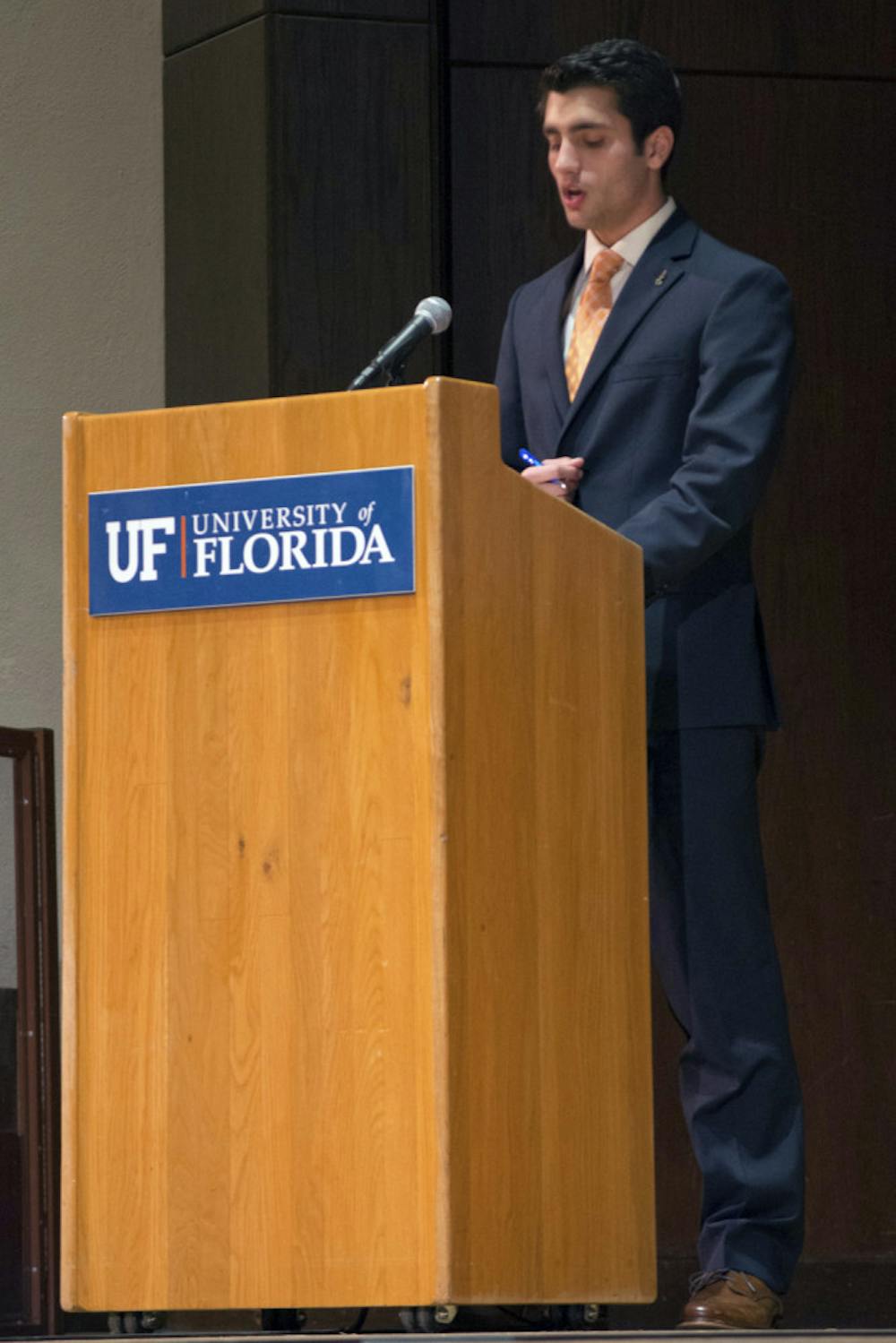 <p>Swamp Party presidential candidate Joseph Michaels, an economics and political science senior, presents his opening statement at the Student Government Executive Debate Tuesday night in the University Auditorium.</p>