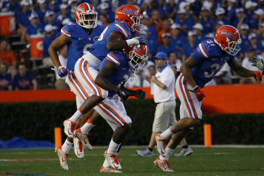 Players celebrate with nickel back Duke Dawson after Dawson's first interception during the Orange &amp; Blue Debut on April 8, 2016, at Ben Hill Griffin Stadium.