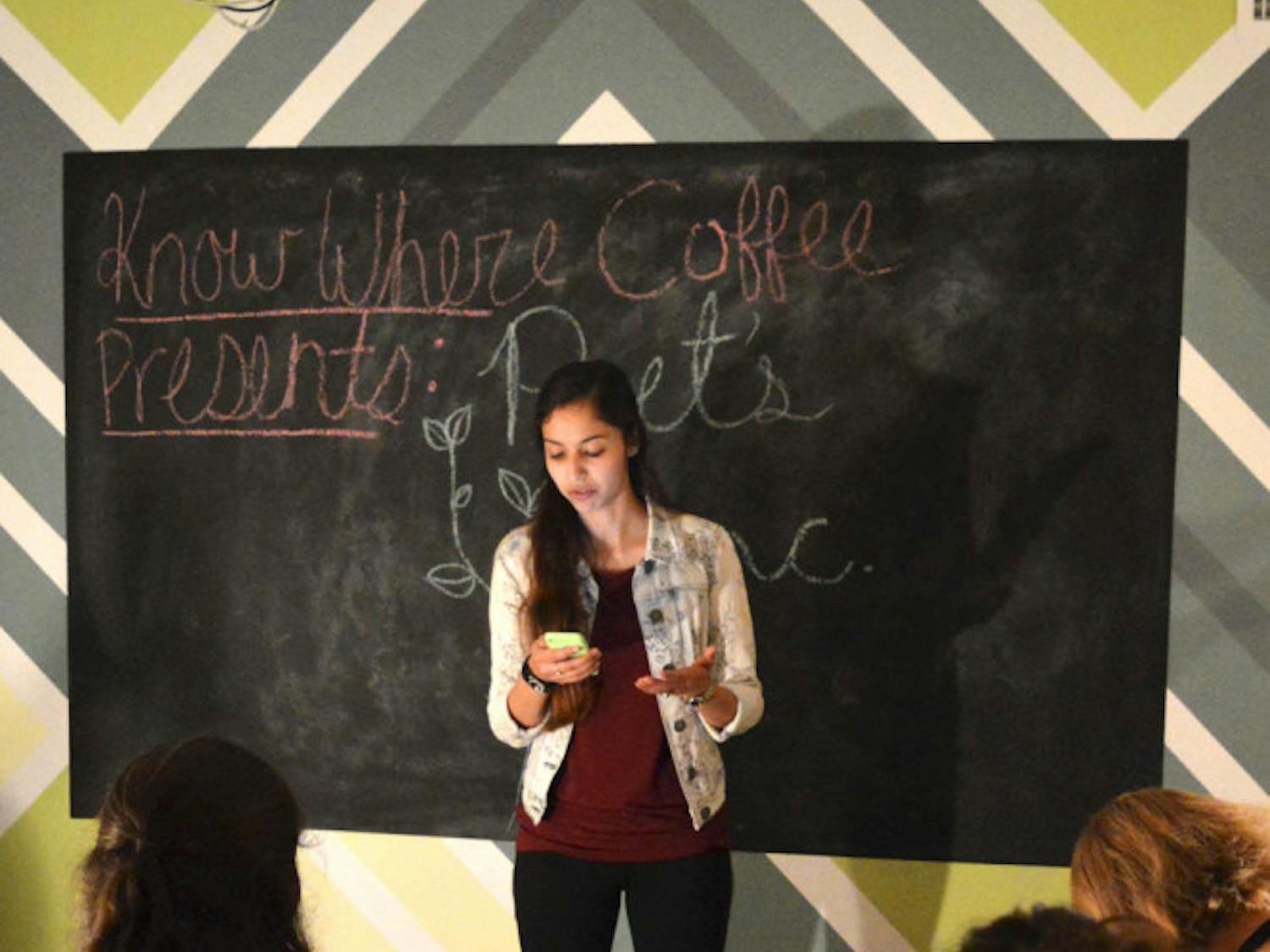 Kelsey Cruz, a 20-year-old UF psychology sophomore, shares a post-Valentine's Day poem with members of Poet's Inc at Know Where Coffee's open mic night Wednesday. The poem was a tribute to being single on Valentine’s Day.