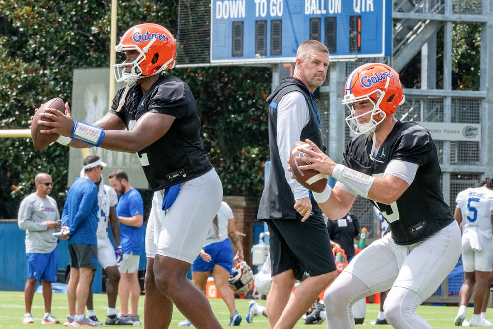 Florida football head coach Billy Napier looks on as freshman DJ Lagway and redshirt senior Graham Mertz practice drills at Florida Football Fall Camp on Thursday, August 1, 2024.