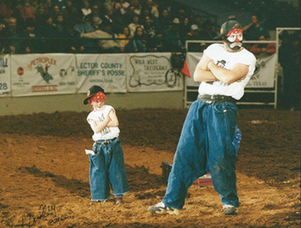 Rodeo clowns Hollywood Harris and his son, Boogerhead, perform a skit in which Harris pulled boogerhead out of a suitcase. Now 22, Boogerhead goes by the name Brinson James the Entertainer. He has been performing with his dad since he was 2.