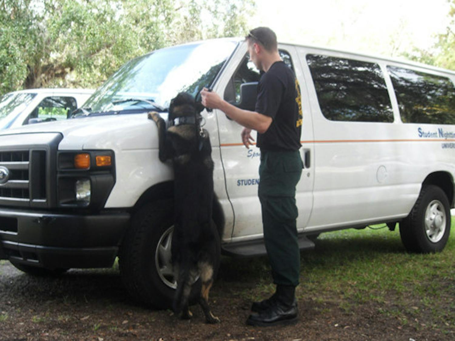 A German shepherd police dog, Apollo, is led by Marion County Sheriff's Office Deputy Greg Combs Friday, sniffing out narcotics for his yearly certification requirements.