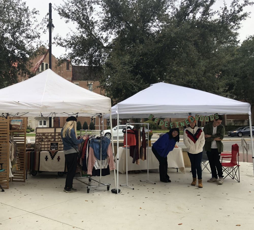 Vendors and visitors bundle up outside of Concord Coffee while perusing Saturday’s market.