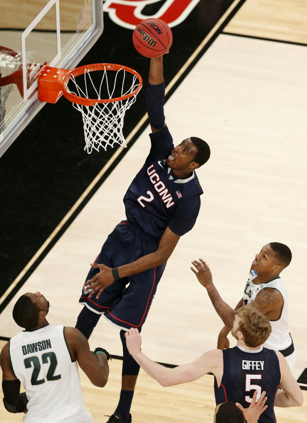 <p>Connecticut forward DeAndre Daniels (2) dunks against Michigan State on Sunday in Madison Square Garden in New York.</p>