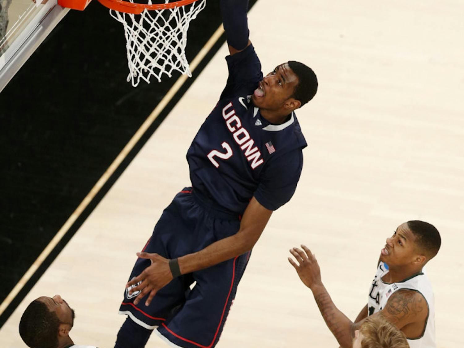 Connecticut forward DeAndre Daniels (2) dunks against Michigan State on Sunday in Madison Square Garden in New York.