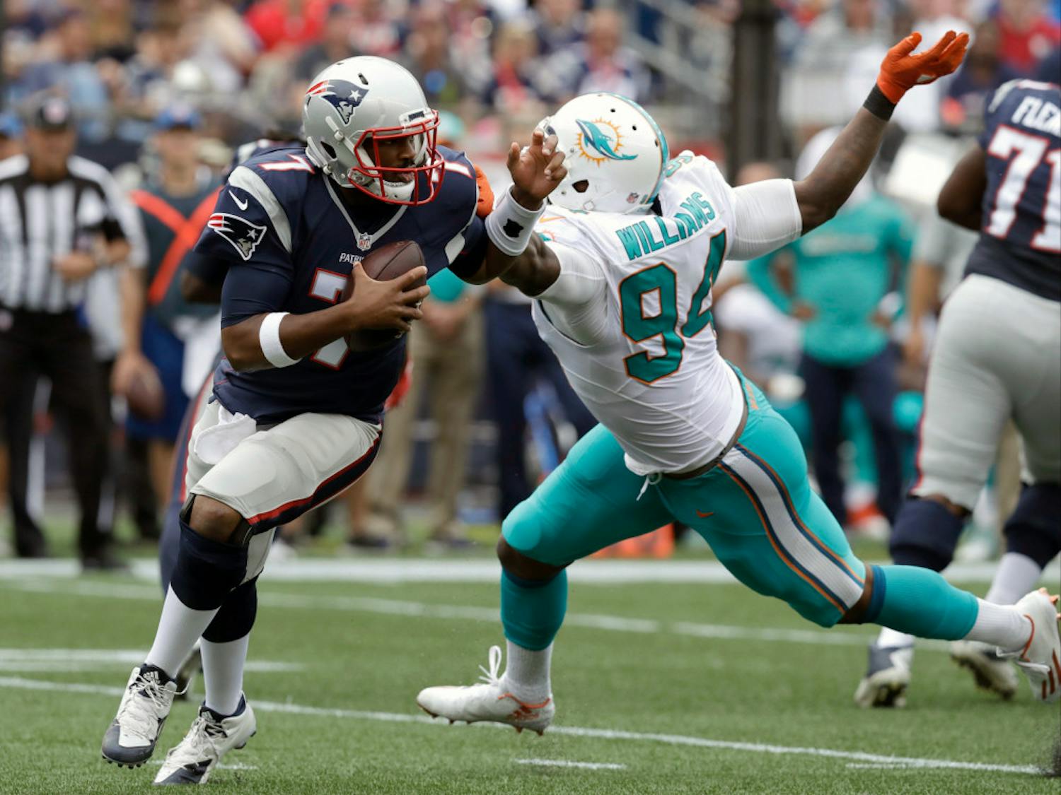New England Patriots quarterback Jacoby Brissett (7) scrambles away from Miami Dolphins defensive end Mario Williams (94) during the second half of an NFL football game Sunday, Sept. 18, 2016, in Foxborough, Mass. (AP Photo/Charles Krupa)