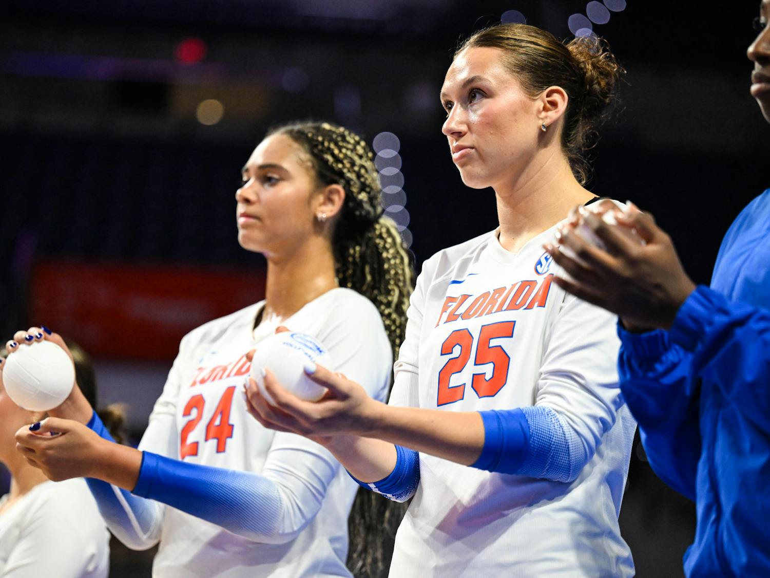 Florida Gators middle blocker Alec Rothe (25) and outside hitter Lauren Harden (24) stand during the lineup announcement before a volleyball match against PVK Olymp Praha of the Czech Republic, on Tuesday, Aug. 26, 2025, at the O'Connell Center in Gainesville, Fla.