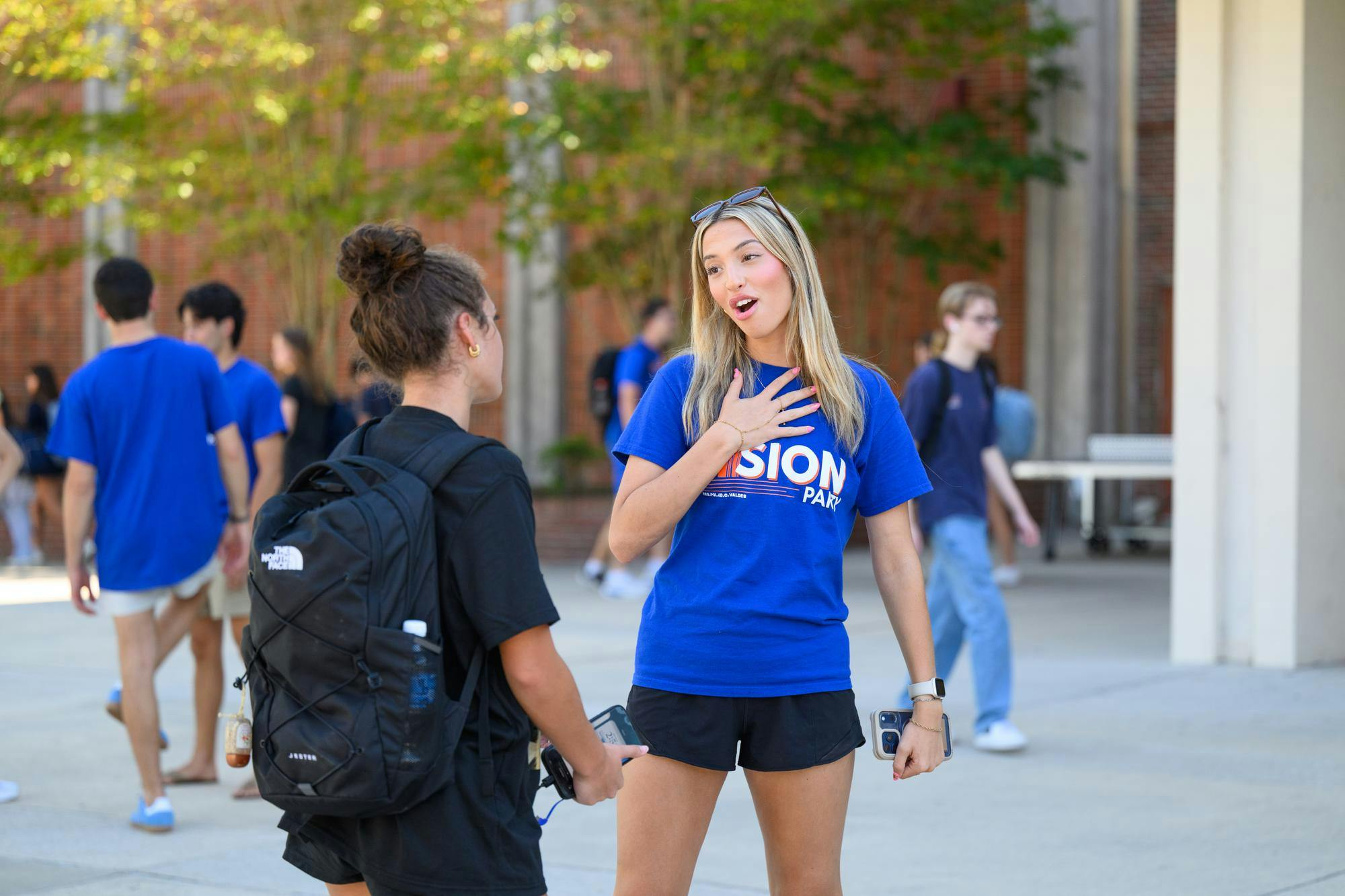 A Vision Party volunteer talks with a student outside the Reitz Union on student government election day, Wednesday, Sept. 30, 2026, in Gainesville, Fla.