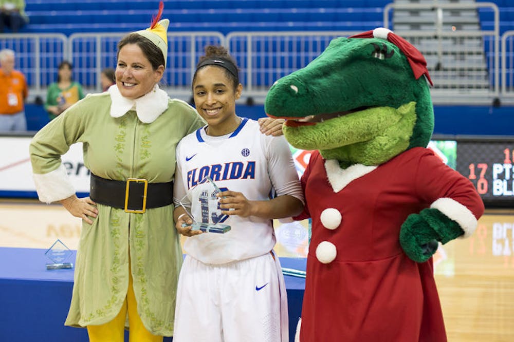 <p>UF soccer coach Becky Burleigh and mascot Alberta present redshirt sophomore Cassie Peoples with the tournament MVP award after Florida's 90-74 win over FIU on Saturday in the O’Connell Center.</p>