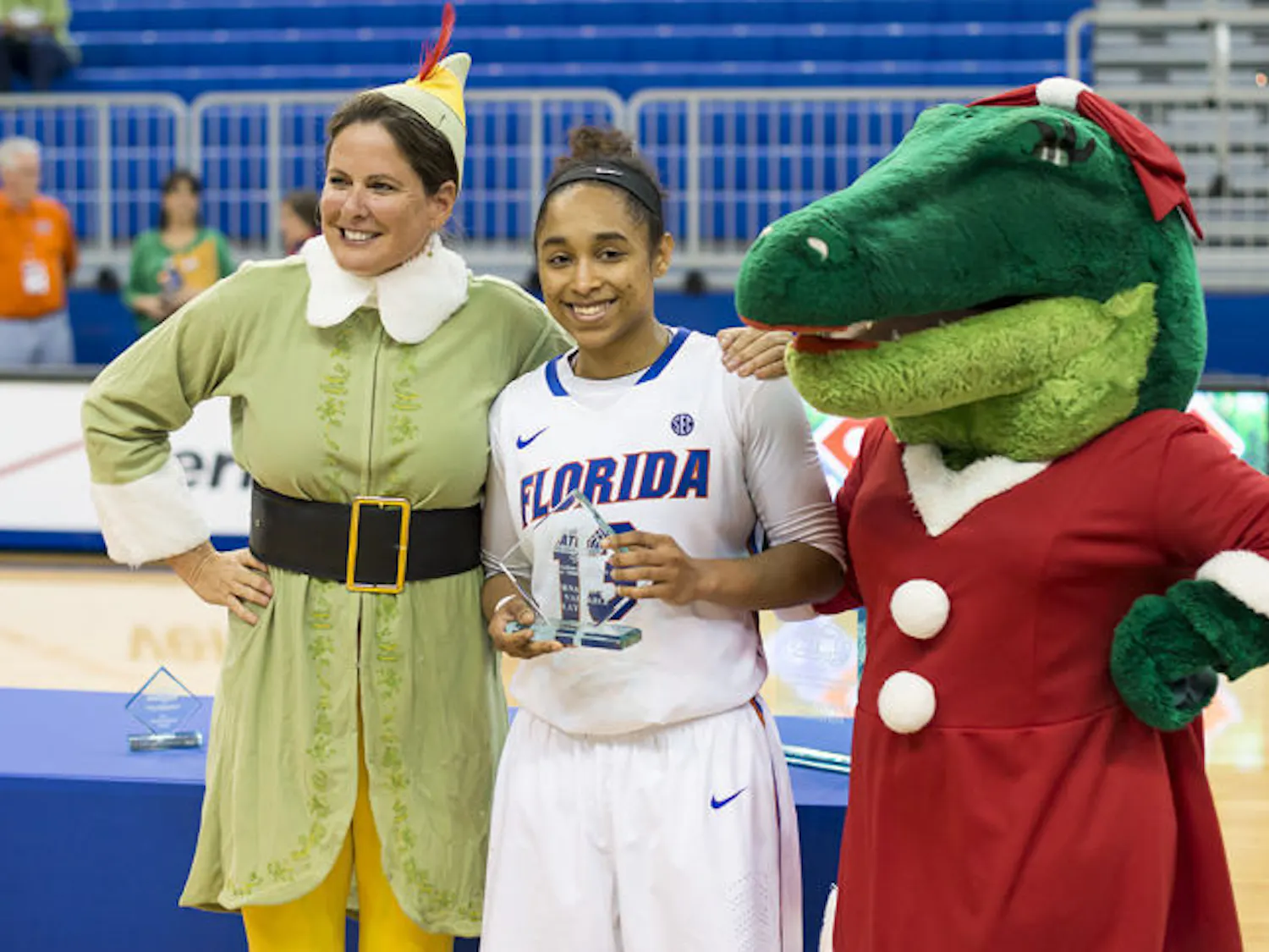 UF soccer coach Becky Burleigh and mascot Alberta present redshirt sophomore Cassie Peoples with the tournament MVP award after Florida's 90-74 win over FIU on Saturday in the O’Connell Center.