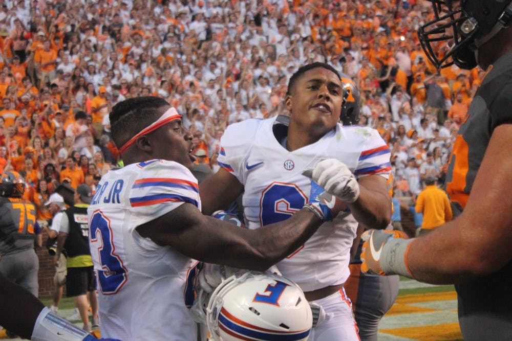 <p>Quincy Wilson (right) is held back by Chauncey Gardner in front of Tennessee players during Florida's 38-28 loss to the Volunteers on Sept. 24, 2016, at Neyland Stadium.</p>