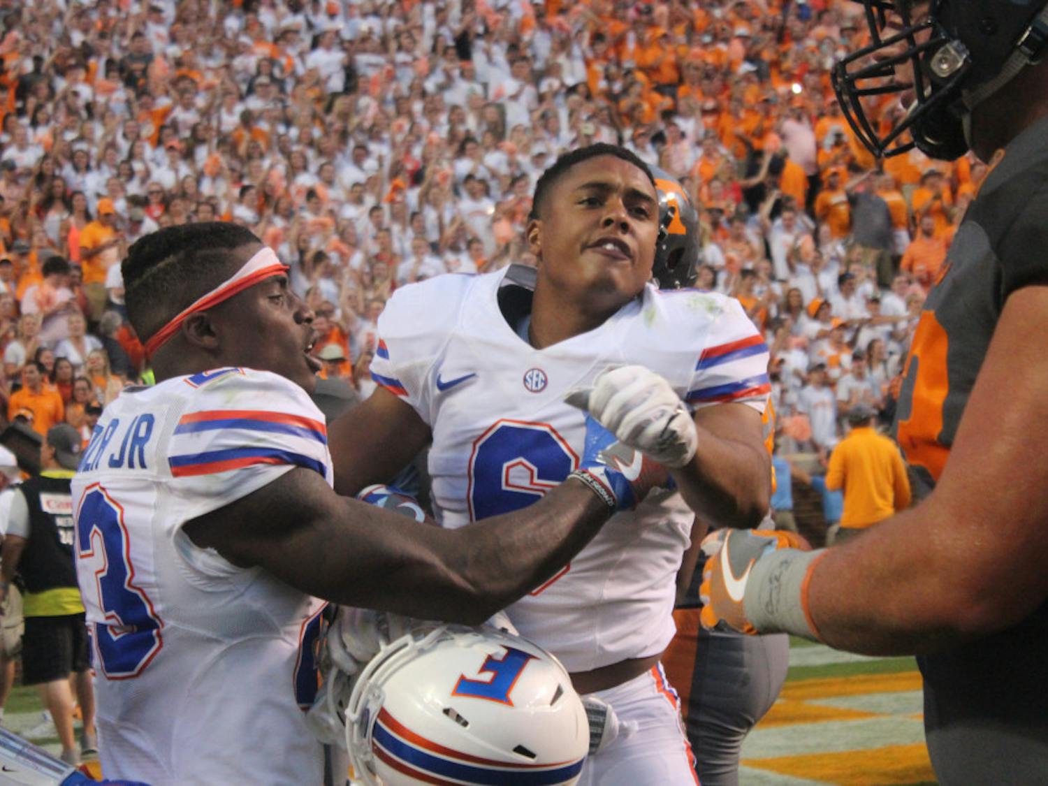 Quincy Wilson (right) is held back by Chauncey Gardner in front of Tennessee players during Florida's 38-28 loss to the Volunteers on Sept. 24, 2016, at Neyland Stadium.