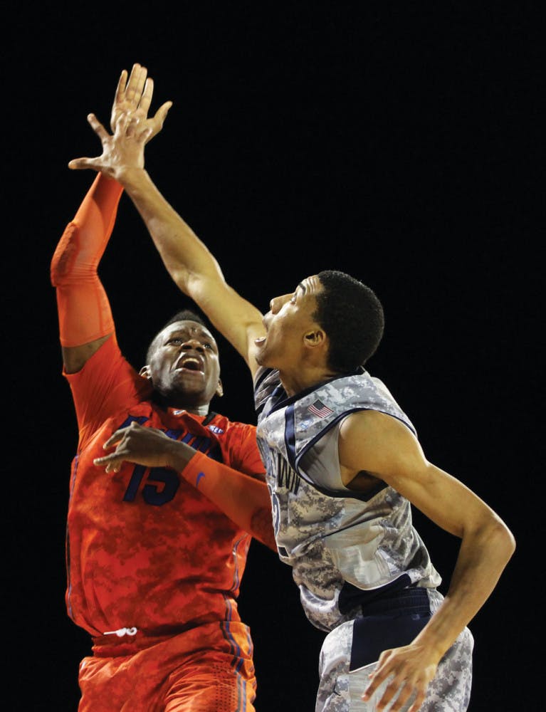 Florida forward Will Yeguete (15) attempts a shot against Georgetown forward Otto Porter on Nov. 9 aboard the USS Bataan in Jacksonville.
