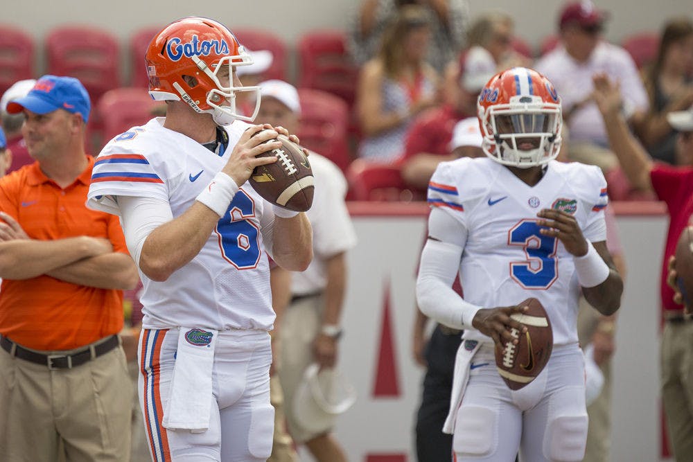 <p>Jeff Driskel warms up prior to Florida's 42-21 loss to Alabama while backup quarterback Treon Harris watches.</p>