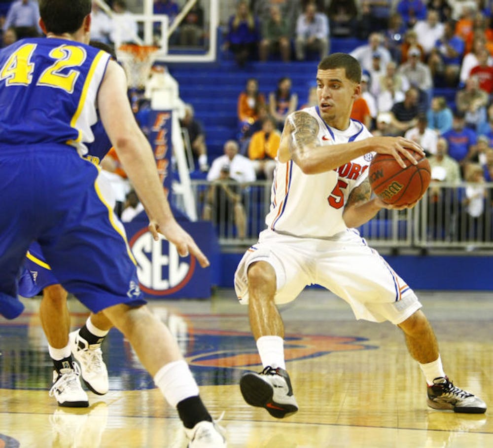 <p>Guard Scottie Wilbekin looks to pass the ball against Nebraska-Kearney on Nov. 1 at the O’Connell Center. Wilbekin is suspended indefinitely.</p>