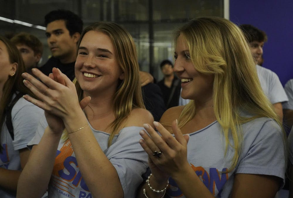 Kendall Walsworth and fellow Vision party ambassador celebrates a Vision party victory in the J. Wayne Reitz Union on Feb. 26, 2025.