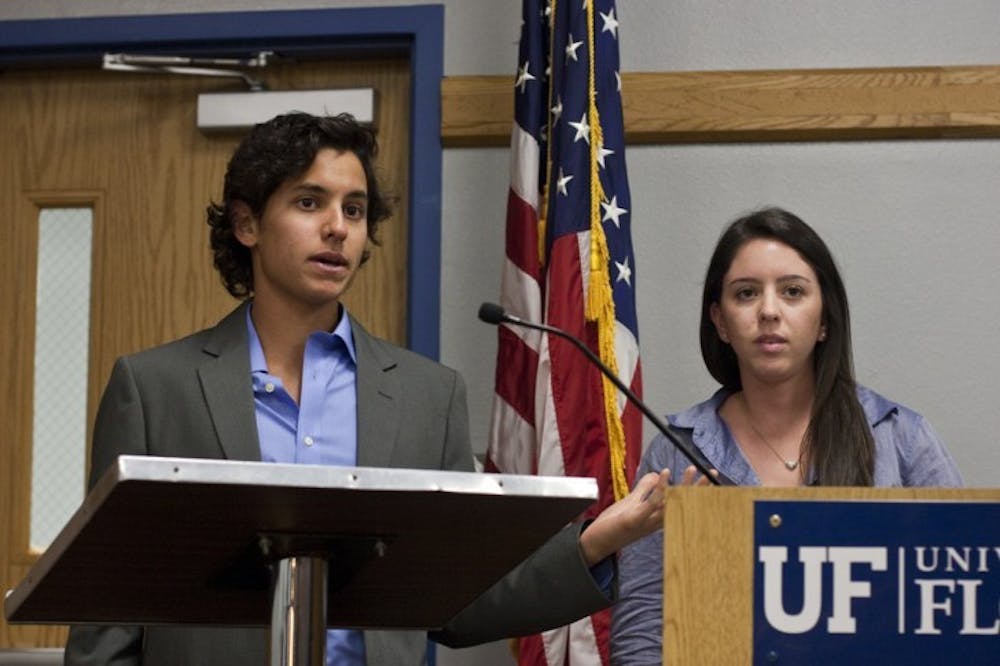 <p>Gators Going Green Student Outreach Director Alex Palomino and Agency Head Brittnie Baker speak at the Student Senate meeting Tuesday night.</p>