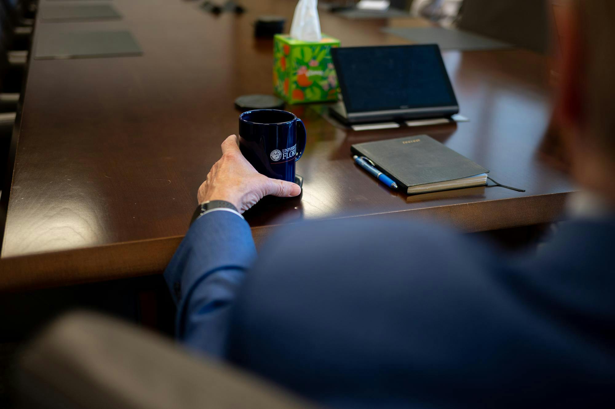 UF President Dr. Stuart Bell holds a University of Florida mug during an interview in the Presidential Conference Room at Tigert Hall, Thursday, Aug. 14, 2026, in Gainesville, Fla.