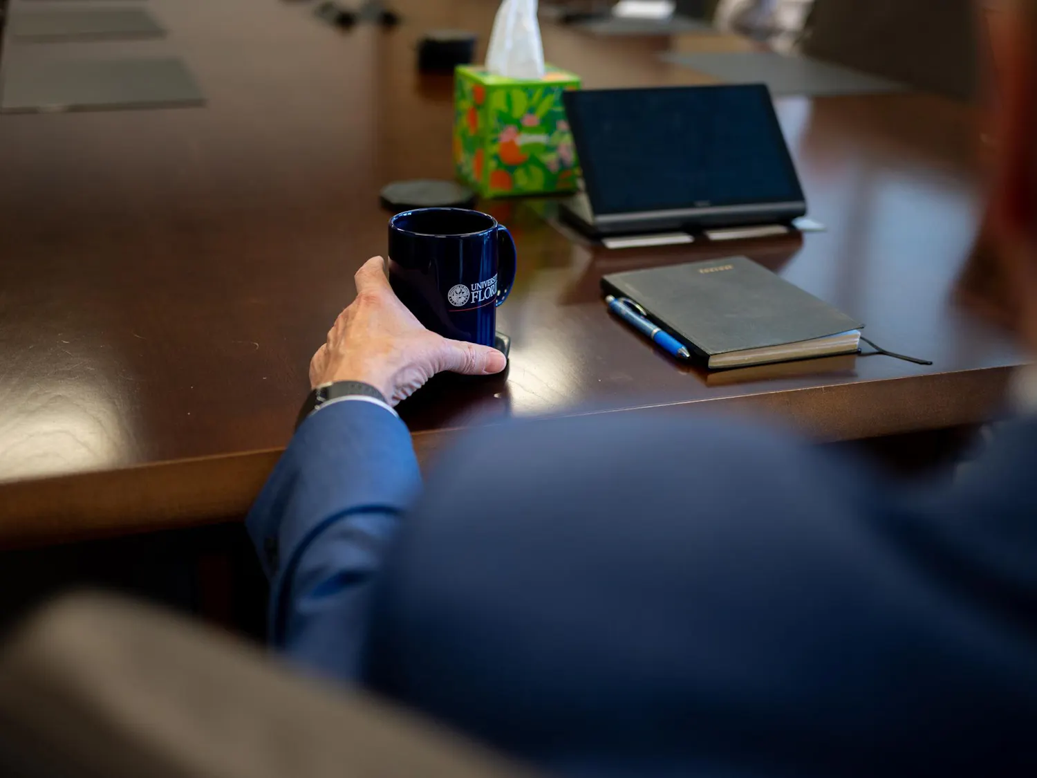 UF President Dr. Stuart Bell holds a University of Florida mug during an interview in the Presidential Conference Room at Tigert Hall, Thursday, Aug. 14, 2026, in Gainesville, Fla.