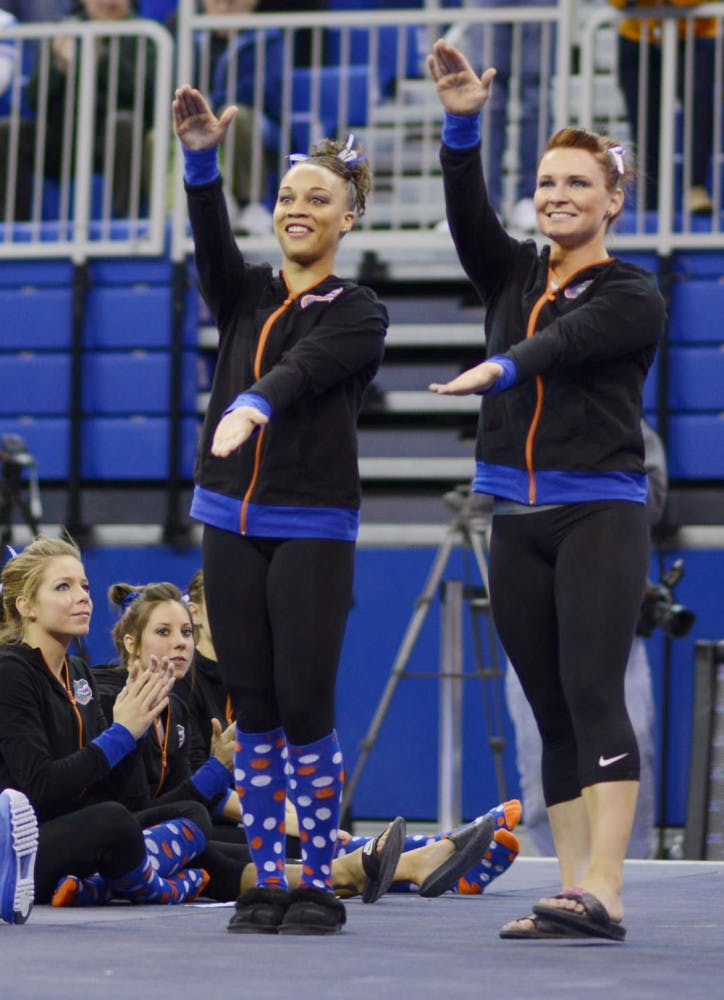 Bridget Sloan and Kytra Hunter celebrate following Florida’s match against Georgia on Jan. 24 in the O’Connell Center.