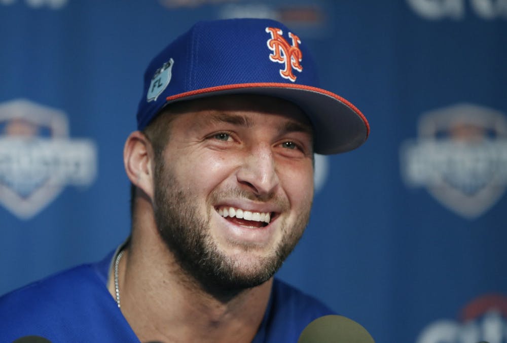 New York Mets outfielder and former NFL quarterback Tim Tebow laughs during a news conference at the baseball teams spring training facility in Port St. Lucie, Fla., Monday, Feb. 27, 2017. (AP Photo/John Bazemore)