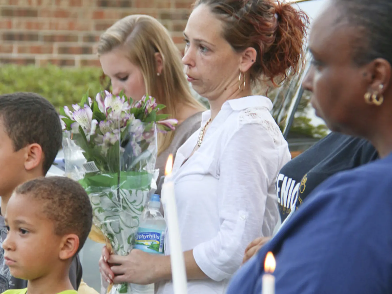 Jennifer Appel mourns her son, Robert Dentmond, who died at a Gainesville apartment building last week, at Powerhouse Church on Monday night. About 30 people, including both family and strangers, showed up for the candlelit service.