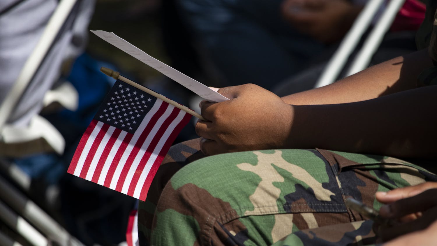 One of the Milton Lewis Young Marines holds a small flag during the Veterans Day event at the Historic Evergreen Cemetery.