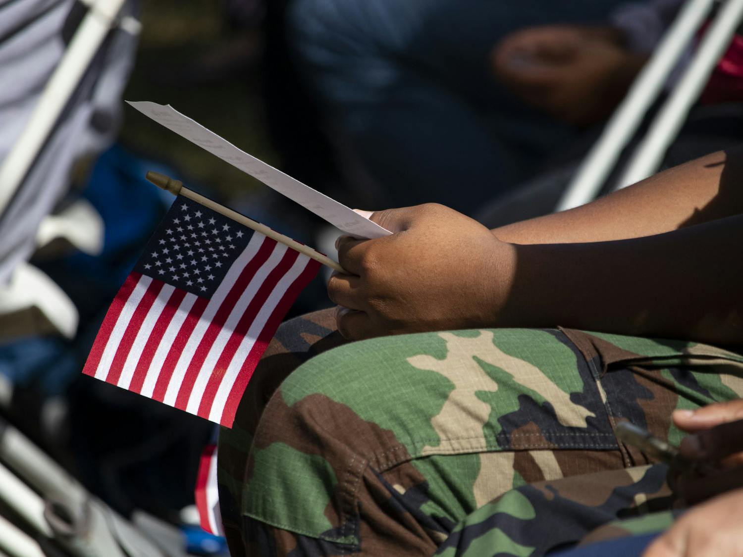 One of the Milton Lewis Young Marines holds a small flag during the Veterans Day event at the Historic Evergreen Cemetery.