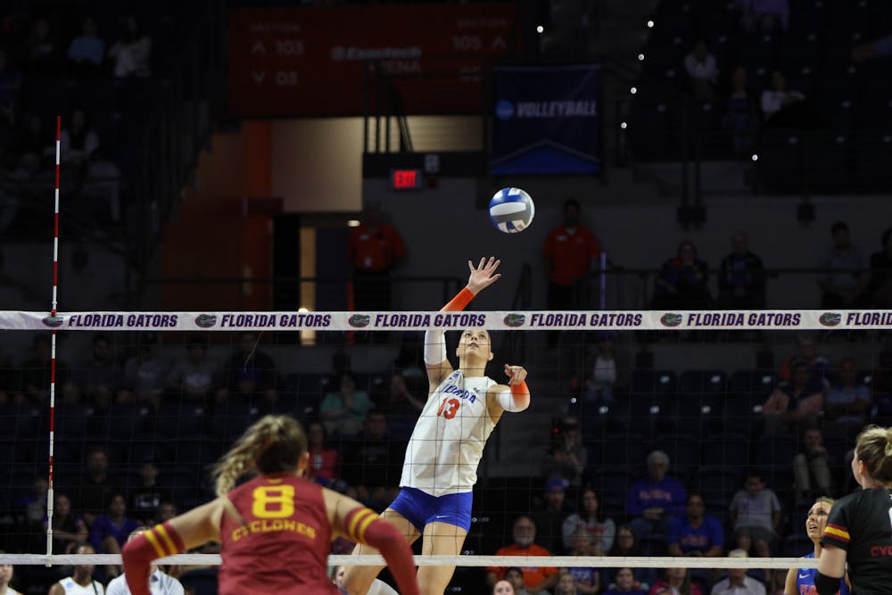Sophomore outside hitter Merritt Beason rises high above the net to hit the ball during Florida's match against Iowa State Saturday Dec. 3, 2022. 