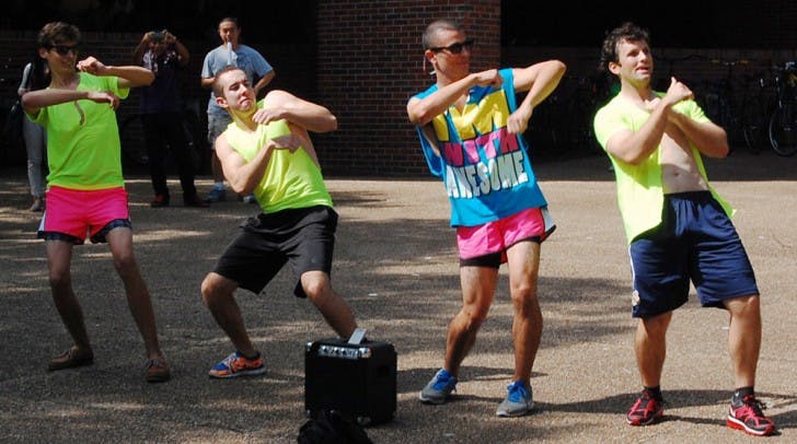 Kyle McIntosh, an 18-year-old biology freshman; John Smith, a 19-year-old journalism sophomore; Steven Perkavic, a 19-year-old accounting sophomore; and Jason Jones, a 21-year-old biology junior; dance on Turlington Plaza on Thursday afternoon. McIntosh said the boys had lost a bet regarding the UF football game against Kentucky on Sept. 1.