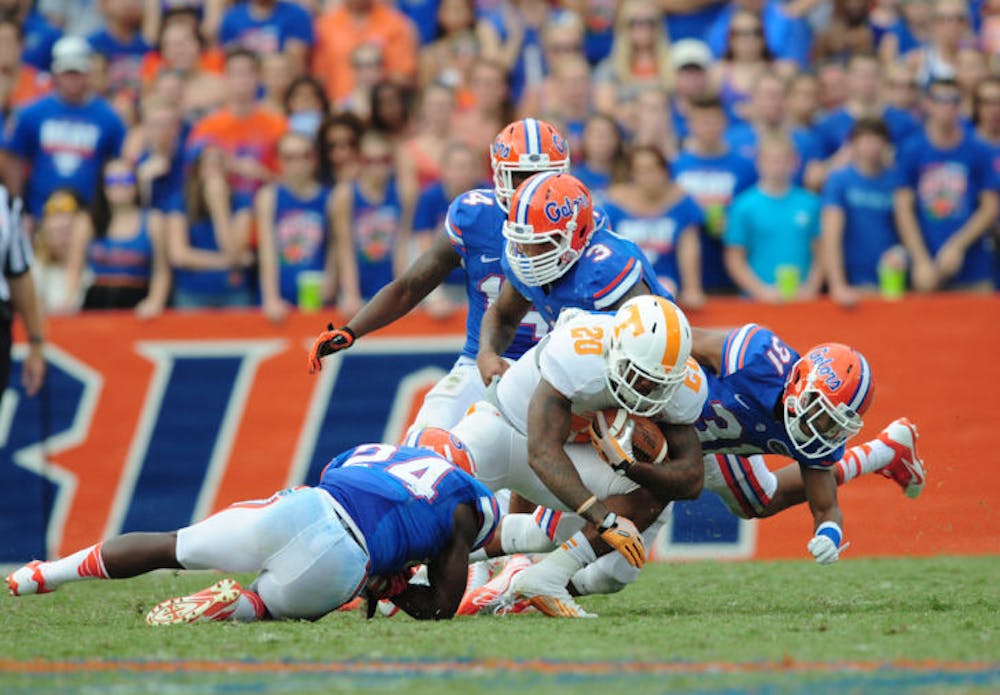 <p>Four Gators converge to tackle Volunteers running back Rajion Neal (20) during Florida’s 31-17 victory against Tennessee on Saturday in Ben Hill Griffin Stadium.</p>